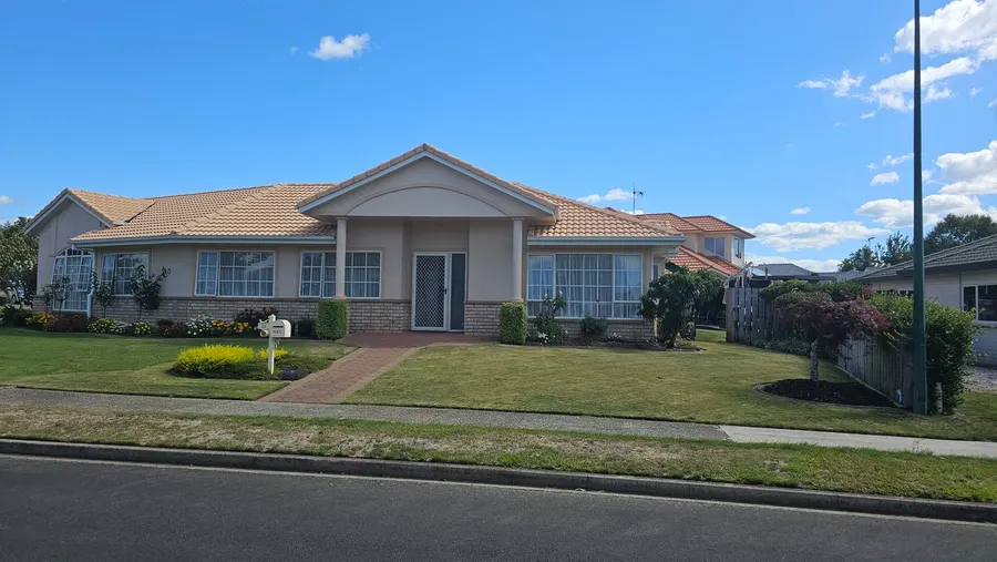 Tidy front lawn and brick house after a mow